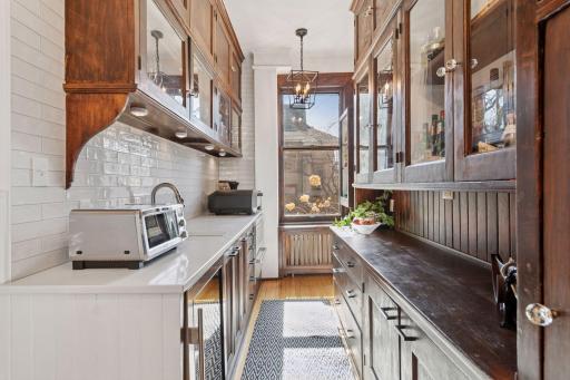 Butler's pantry and wet bar adjacent to kitchen and formal dining room.