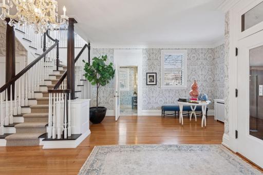 Gracious entry hall with a grand staircase just beyond the entry hall. The central hall includes a large walk-in coat closet and main level powder room.