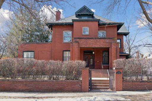 Welcome to 1700 Dupont Ave S. Located in the historic Lowry Hill neighborhood on a double lot at the corner of Mount Curve Avenue and Dupont Ave S. Pass through gates leading up to the covered front porch and terraces.