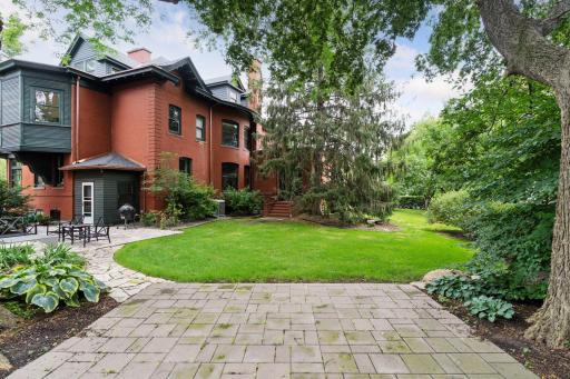 Private double lot with patios, a gas line to the grill, and a wide lawn. The home, garage, elevated lot, and fencing make the yard completely private from the street.