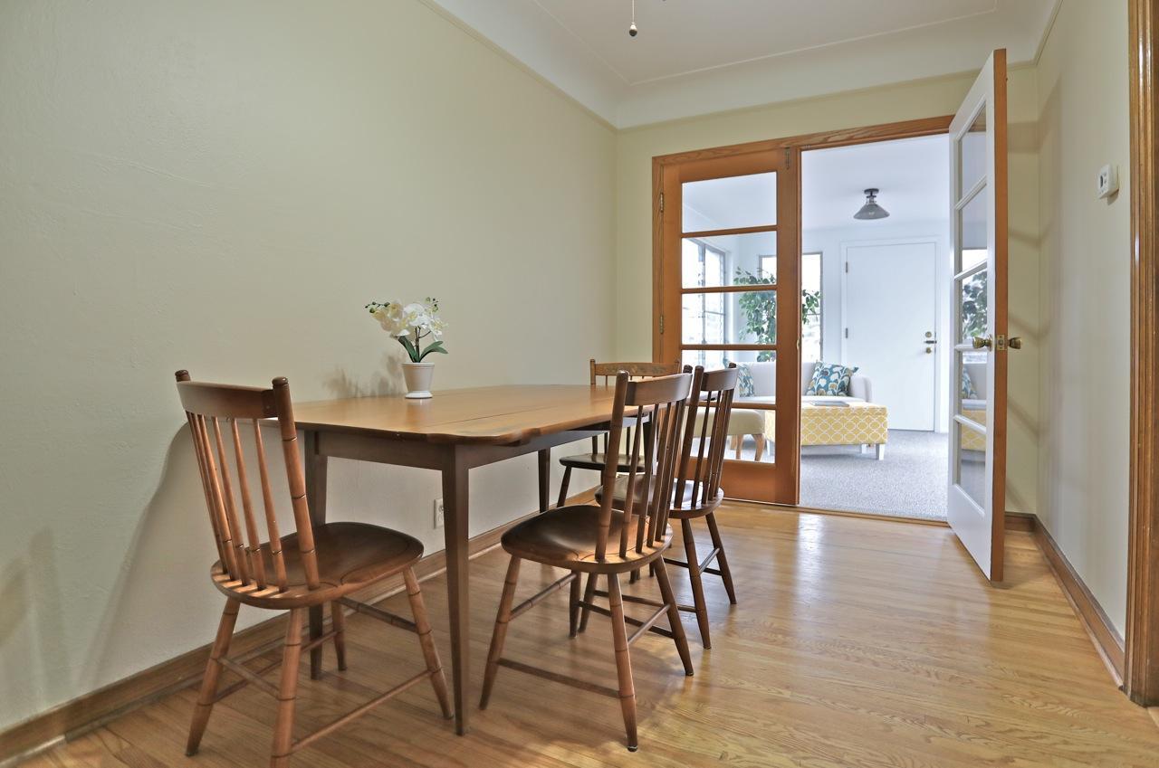 The dining area opens through French doors to a sunny 3-season porch