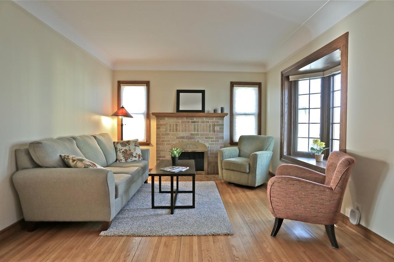 Living room with a fireplace and bay window