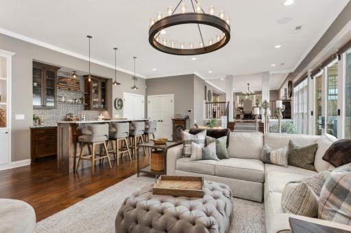 The gathering room has a full bar, fireplace and expansive lake views