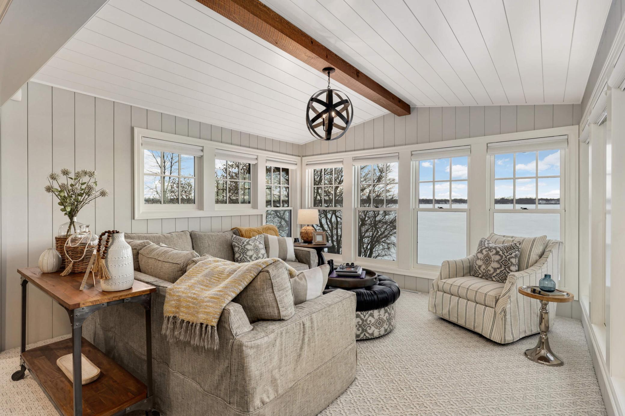 The four season porch is the year round gathering space to enjoy the lake
