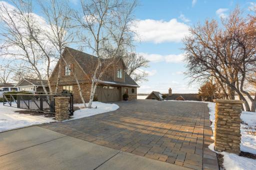 Separate detached garage can fit 4 cars, has a finished space above and the driveway has a mechanical gate