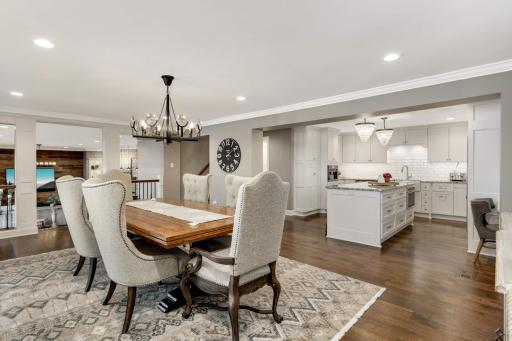 a view showing the dining room as it relates to the kitchen and family room. Beautiful hardwood floors too