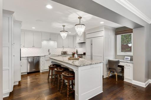 Kitchen has center island, tons of storage and desk nook too