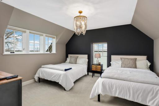 Guest bedroom 2 is in the upper level, also lake facing