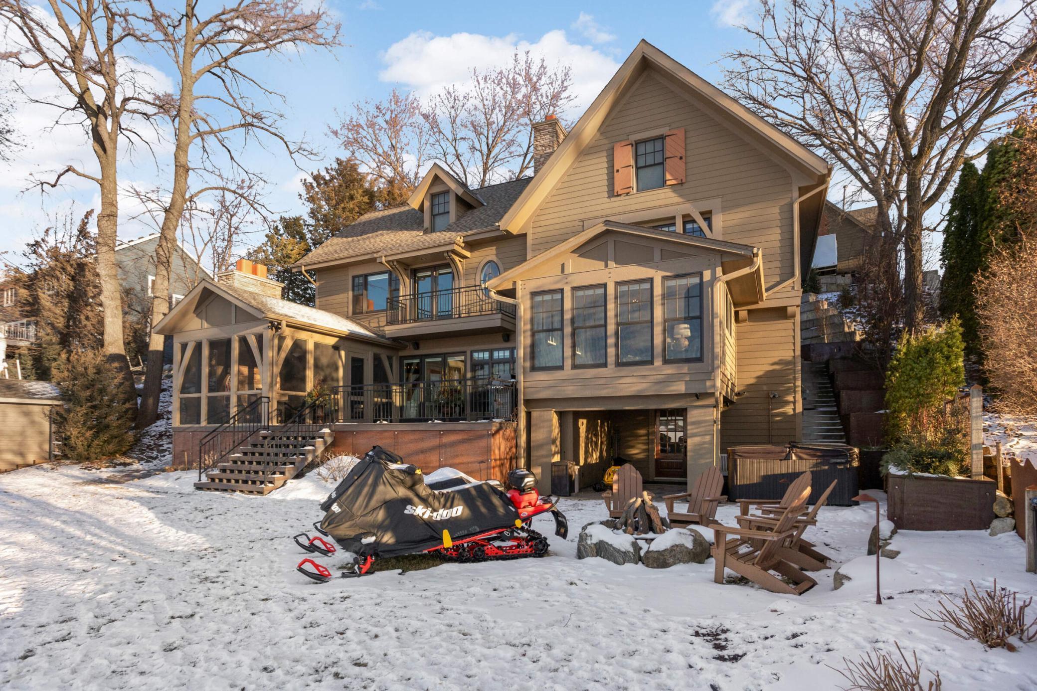 Winter view - great fire pit area too. Note the steps on the right side of the house for easy access. The left side of the house has a ramp for driving vehicles on