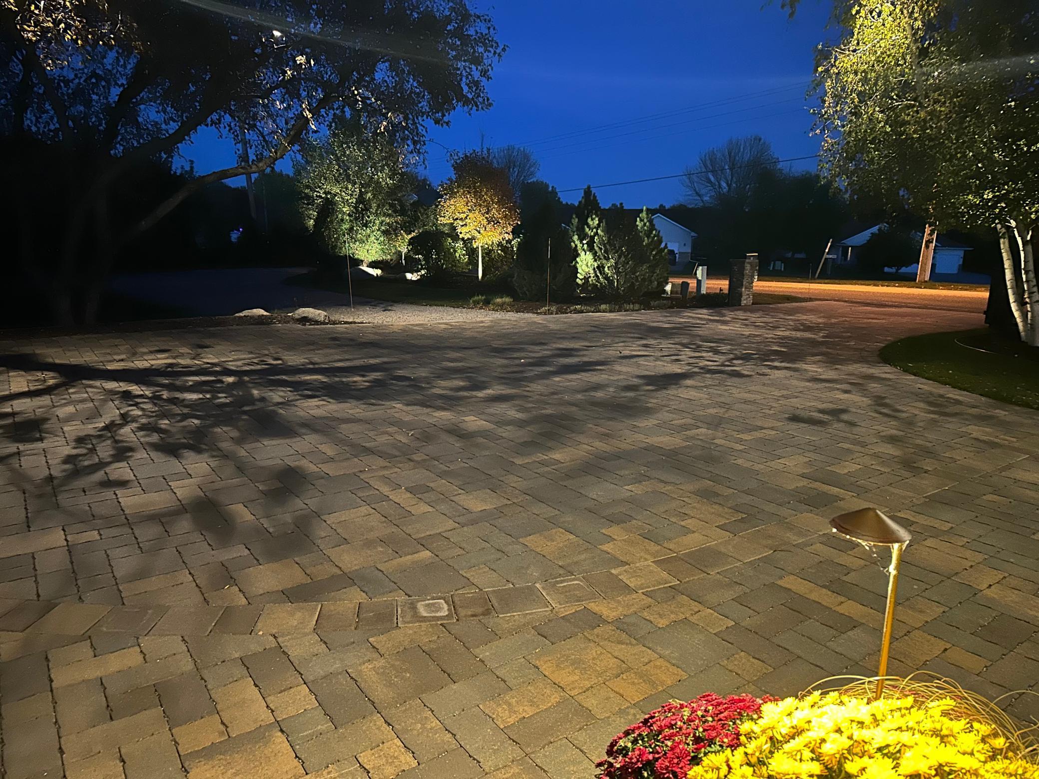The paver driveway was recently redone. Beautiful landscaping plus a driveway gate.