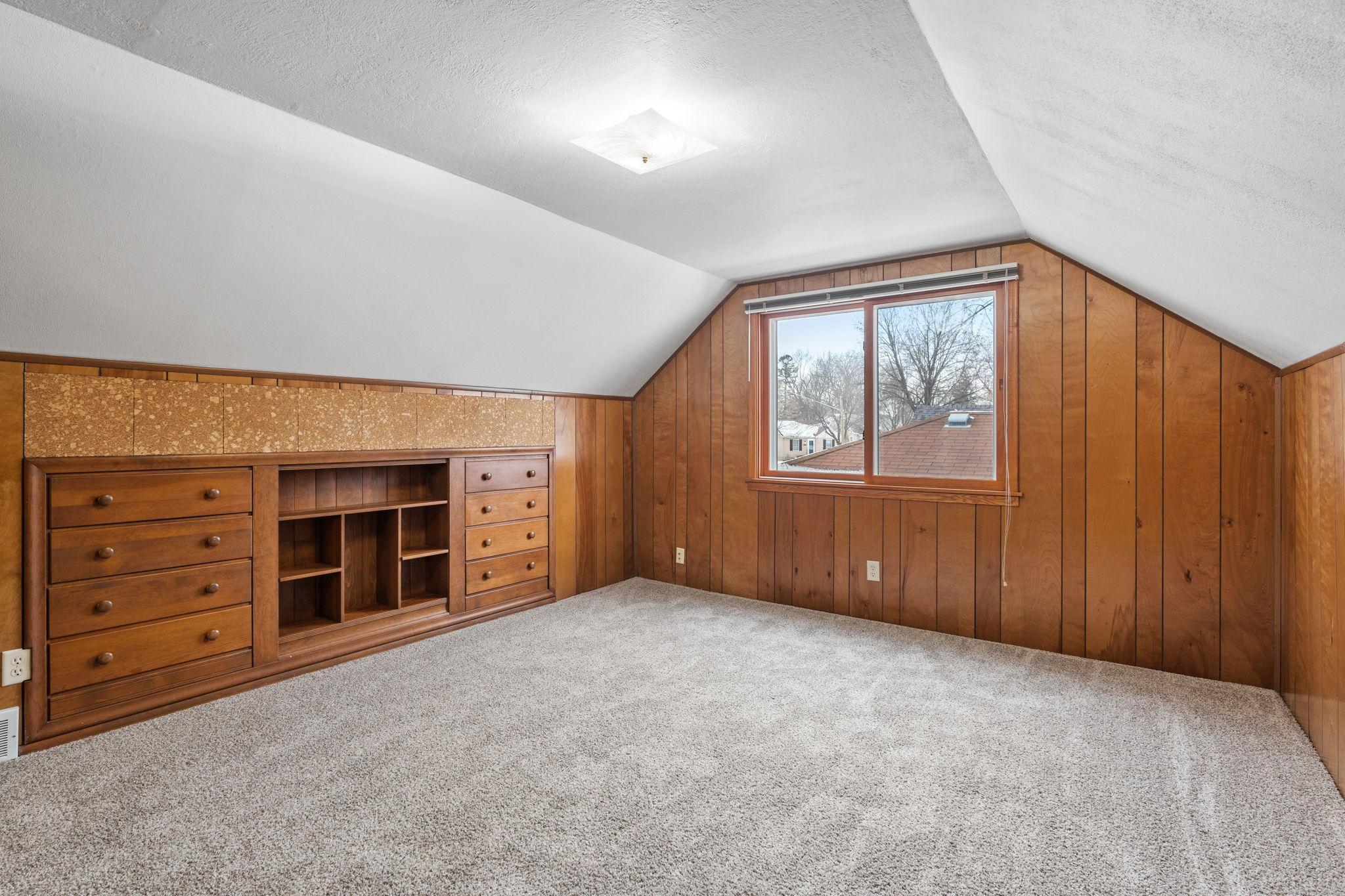 Upper floor primary bedroom and built-in dresser.