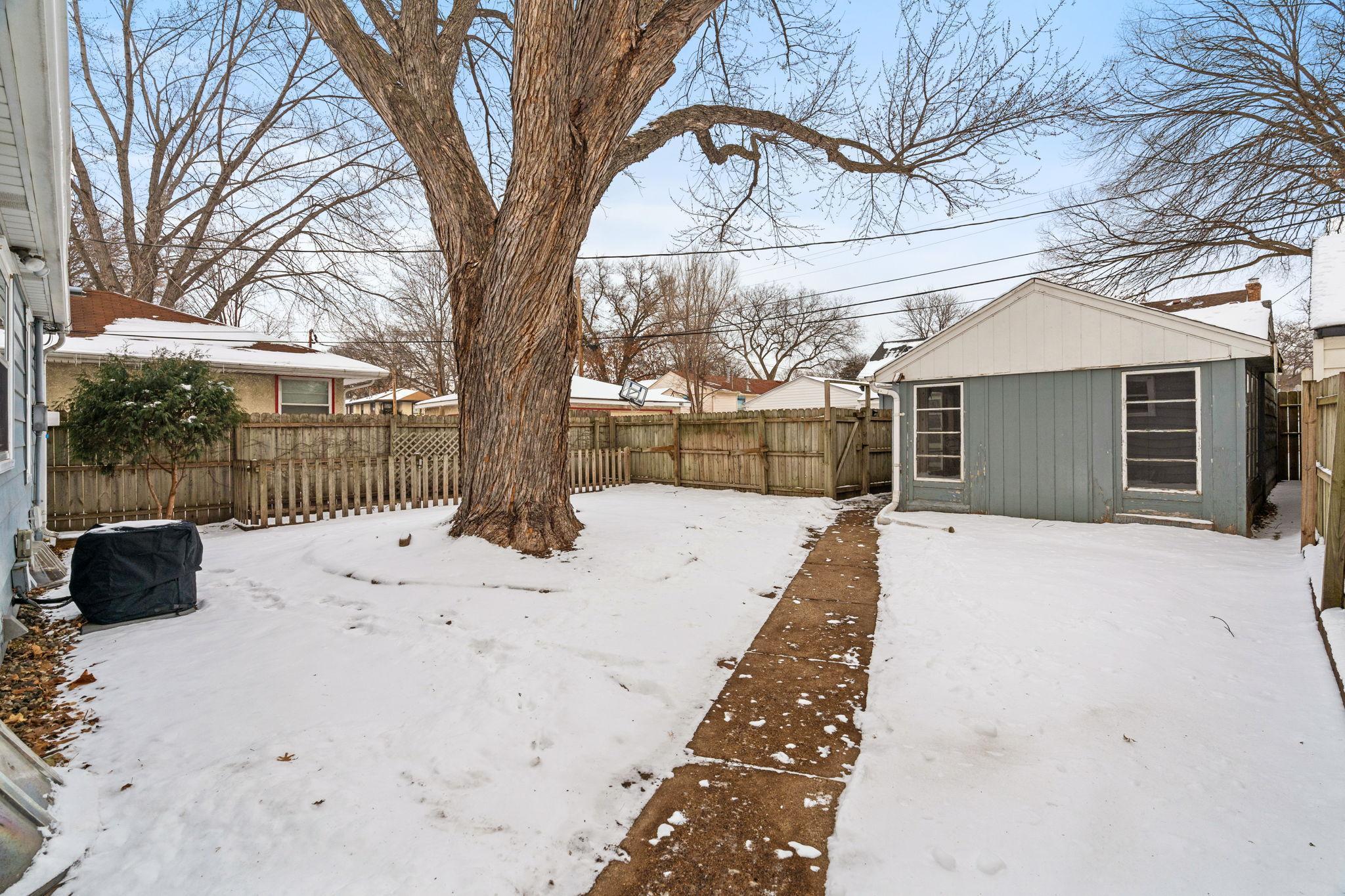 Fully fenced backyard with 3 season porch connected to garage.