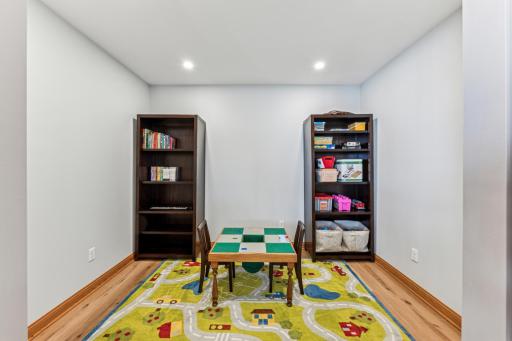 This den, currently being used as a play room can also be easily converted to a home office with double doors to close if needed.