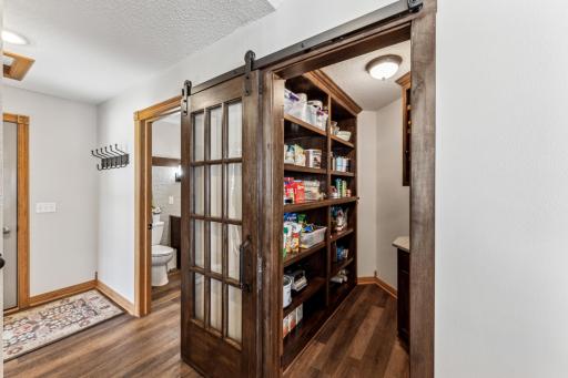 Situated in the hallway toward the garage entrance you can see the walk in pantry as well as the recently added half bathroom.