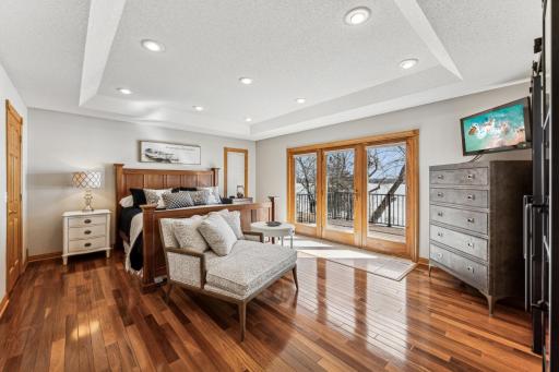 Heading on back you can see hte size of this massive primary suite with its own balcony overlooking Briggs Lake.