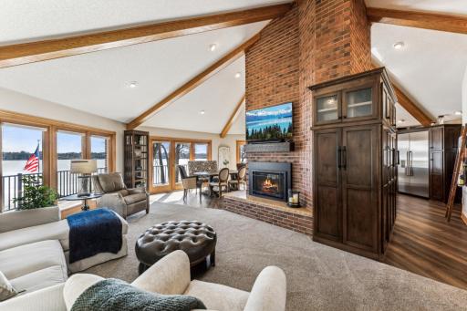Open, spacious and bright as you see 3 large sets of windows and sliding glass door surrounding the floor to ceiling 3 sided gas fireplace.