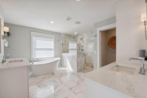 The primary bedroom is luxurious with a spa-like ensuite.