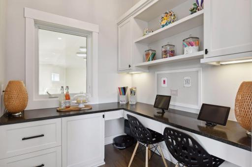 The office nook is off the kitchen and overlooking the sport court.