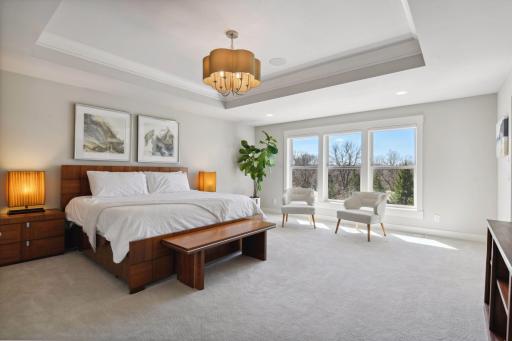 The primary bedroom is luxurious with a spa-like ensuite.
