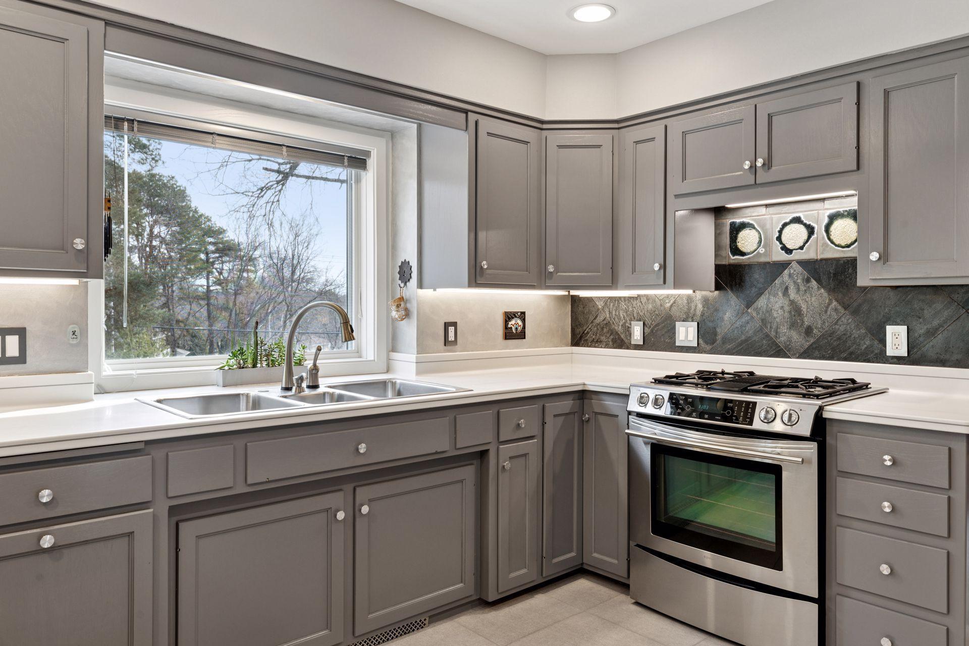 The large picture window fills the space with natural light and frames views of the lush backyard.