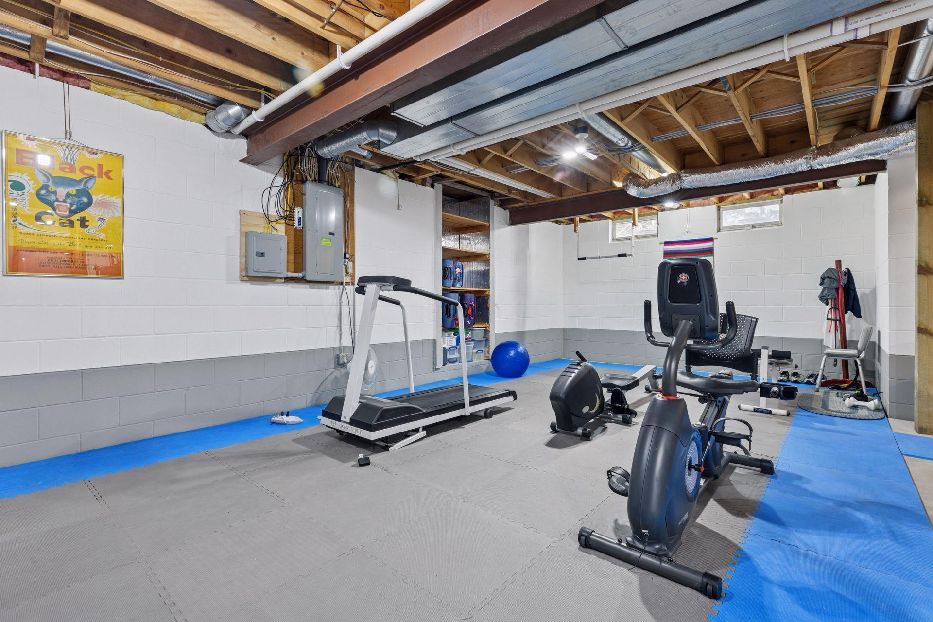 The lower level, currently used as an exercise area and for storage, is full of potential with roughed-in plumbing for a future bathroom.