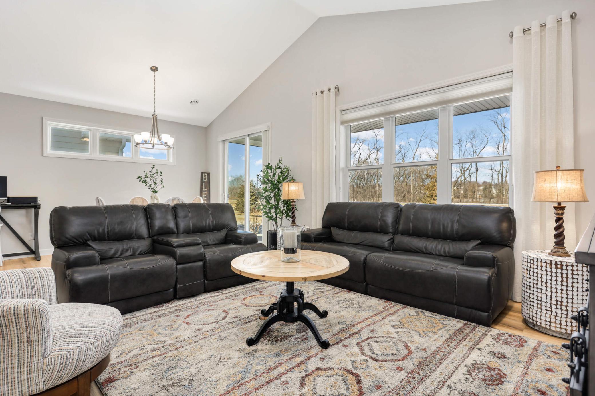 Large windows invite natural light, enhancing the spacious feel of the living room