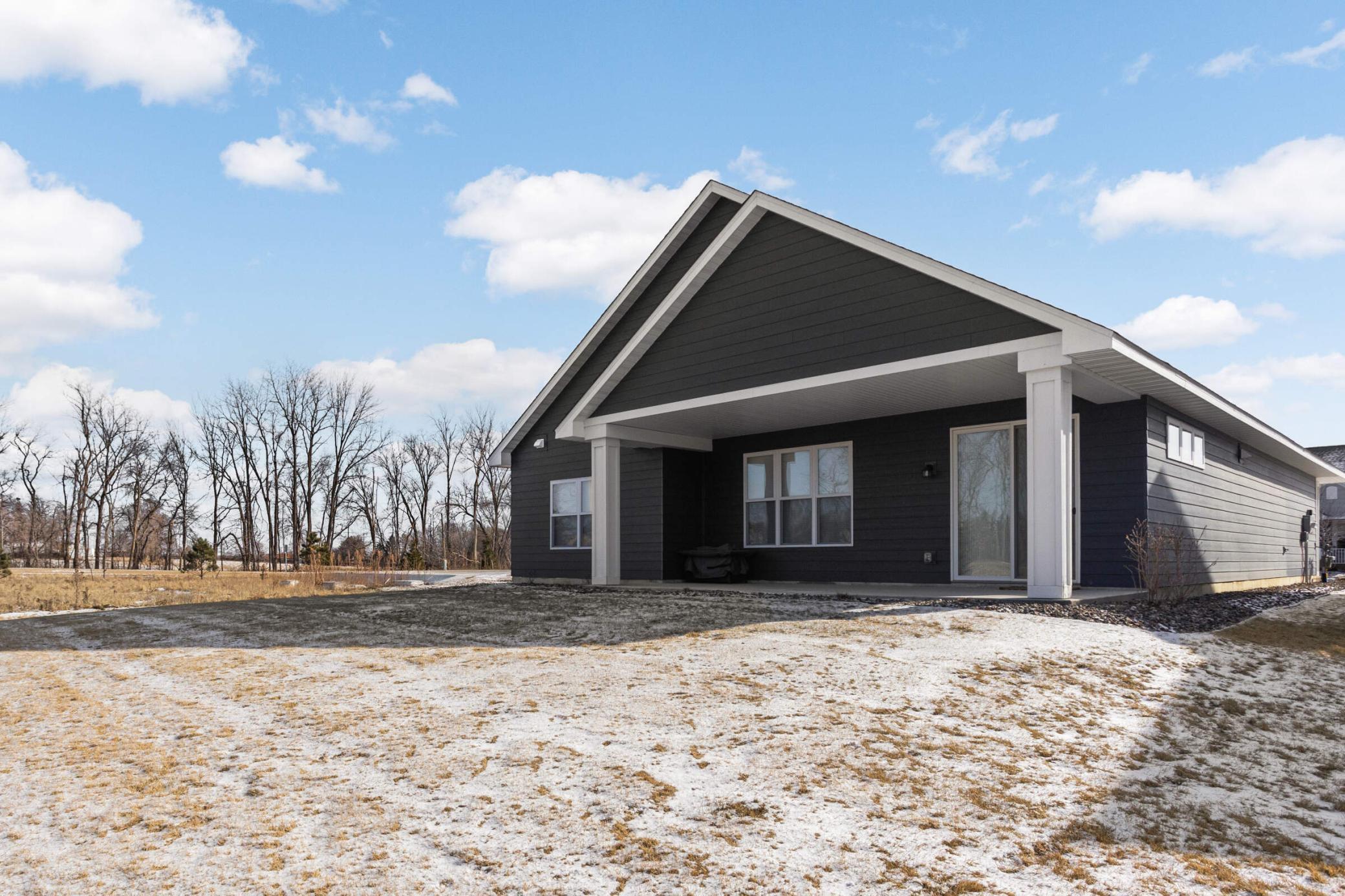 Enjoy outdoor living with a charming back porch that overlooks a private green space