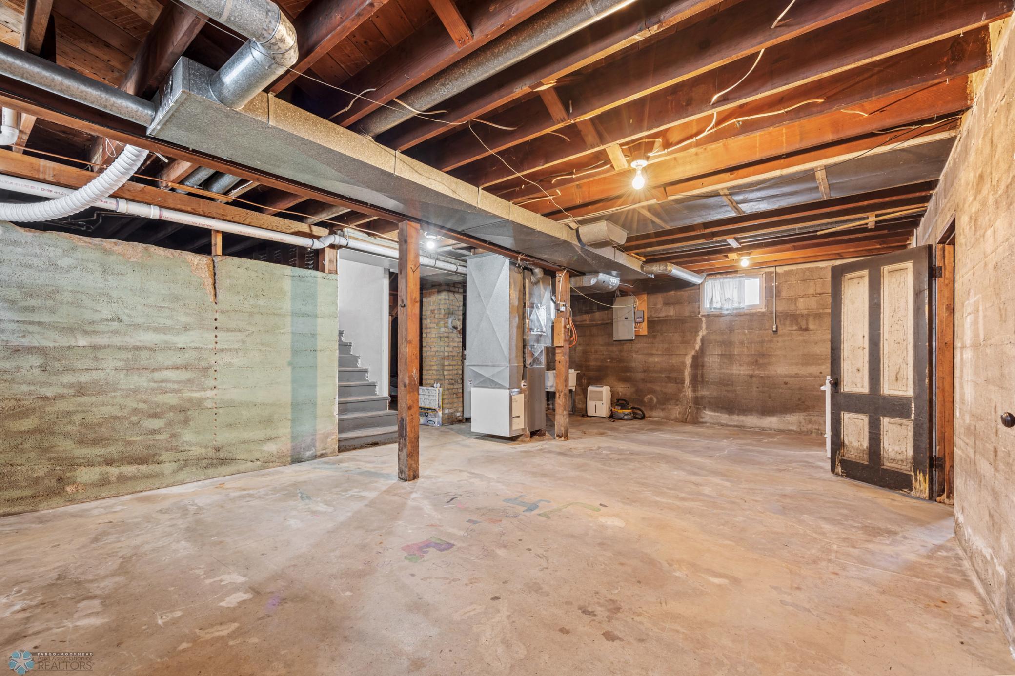 Clean and tall basement, unfinished, updated forced air heat & central air conditioning.
