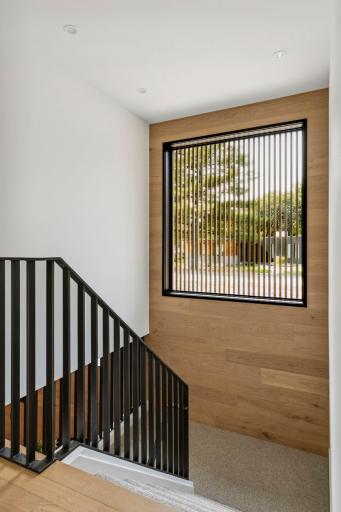 Stairs to lower level. slats in front of the staircase window were designed to be removable in order to clean window.Â 