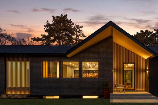 114 Burntside Dr front exterior. combination of Thermally modified pine, white-washed hemlock, white-washed cedar slats, and manganese ironspot full brick.