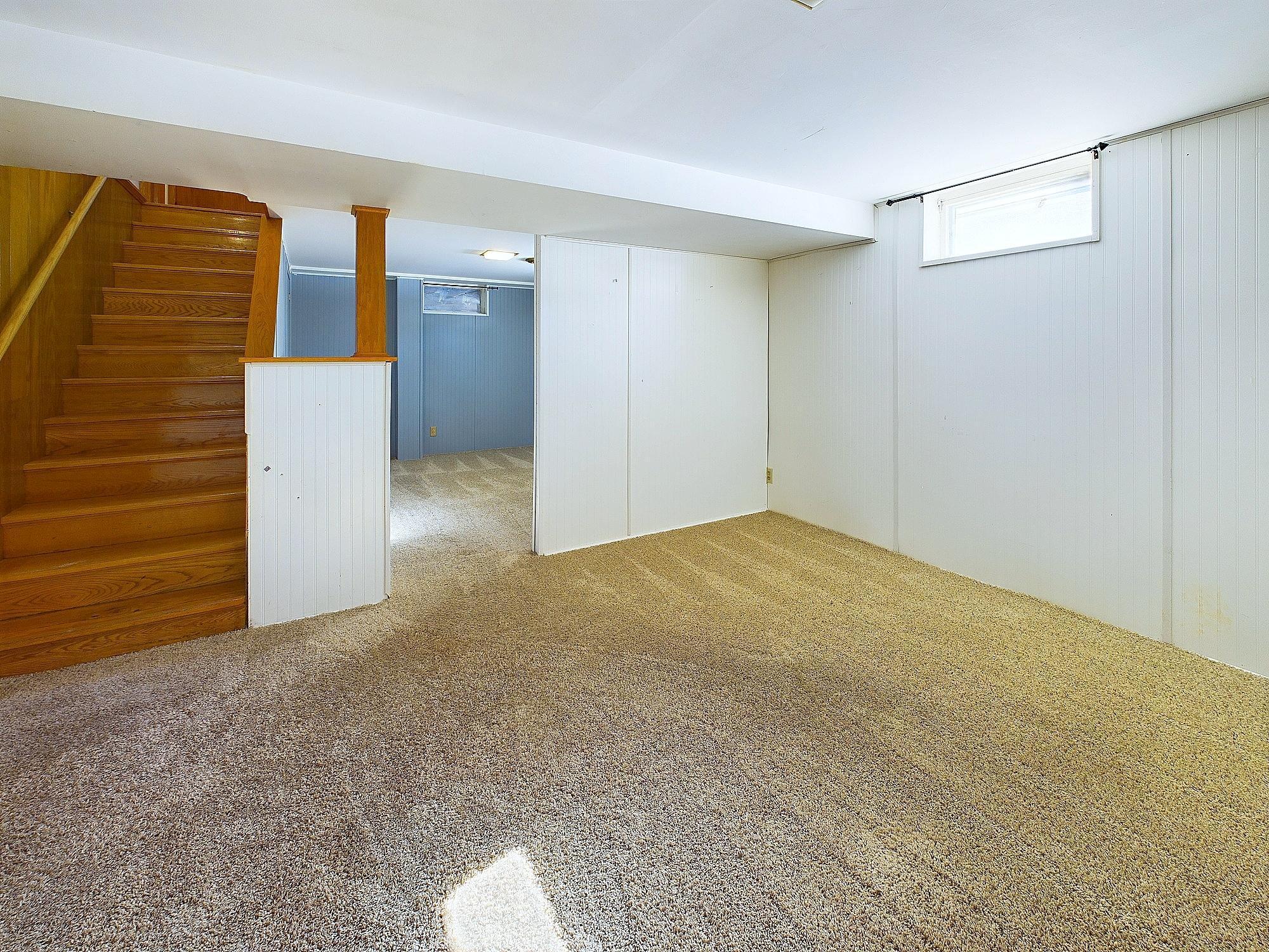 Lower level family room. That half wall is non-load bearing.