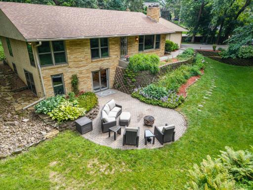Enjoy nature from 3 unique patios in this all-brick Mid-Century Modern five-bed, three-bath home.