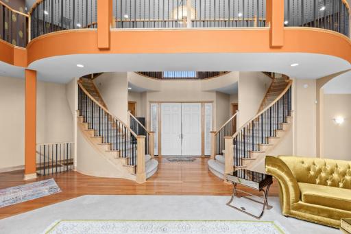 Breathtaking double staircase enhances this homes elegance.