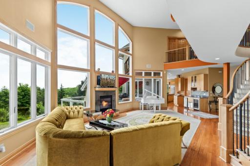 Walls of windows and soaring ceilings flood the home with natural light and frame breathtaking vistas.