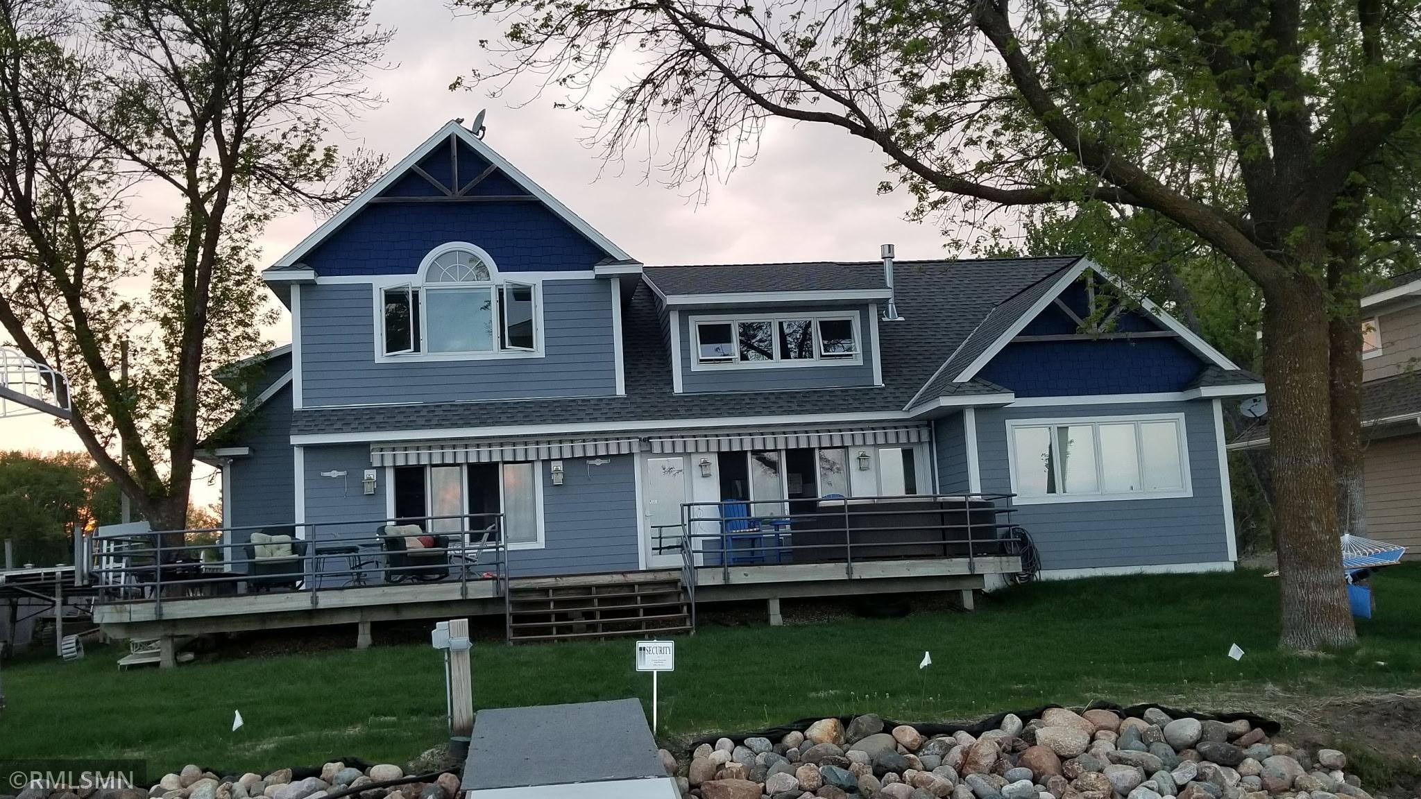 The large lake side deck is great for gatherings at the lake ample seating and quick access to the lake. Great lake side green space for outdoor games.