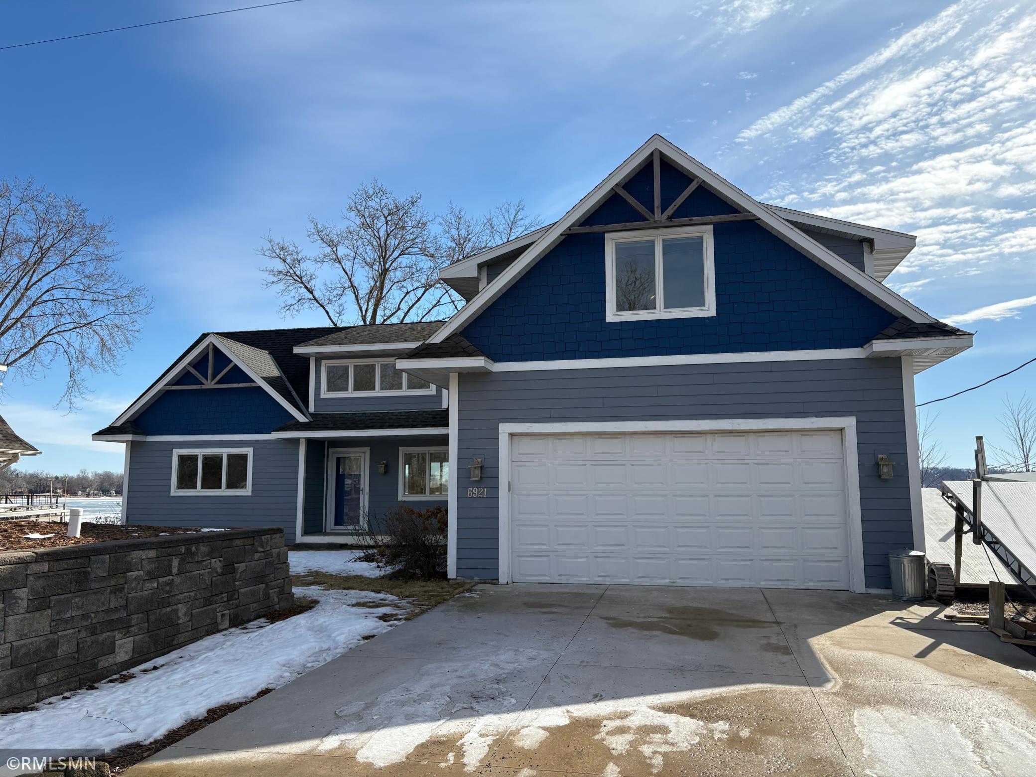 Property has a 2 car attached garage, concrete driveway and hardi board siding.