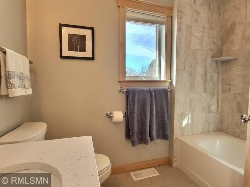 The primary full bath that just received a facelift with new tile floor and tile surround giving it todays modern flair.
