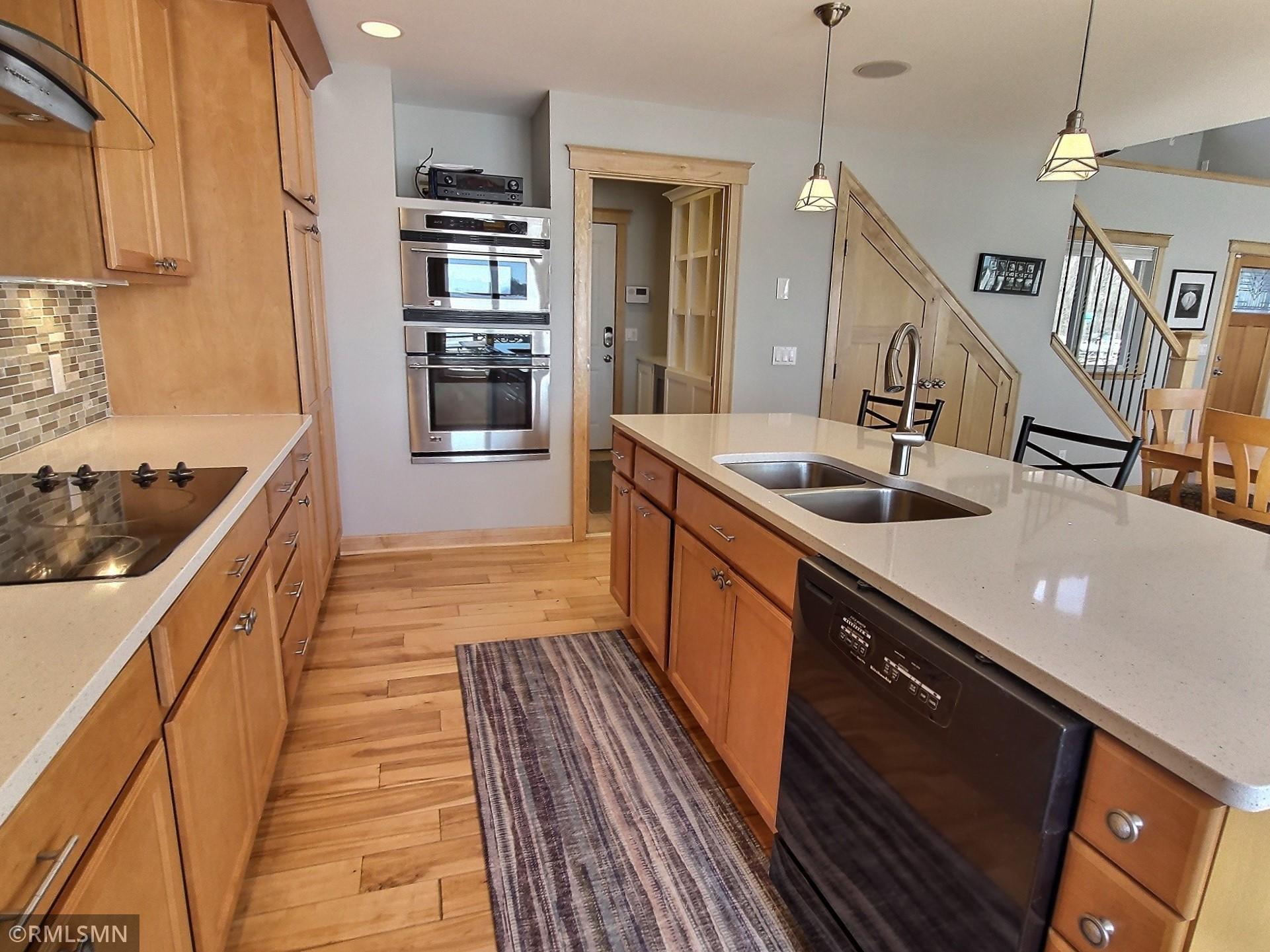 Another view of the kitchen and also in the background you see the mid room with a built in nook and wine fridge. The mechanical room is also located in this area.