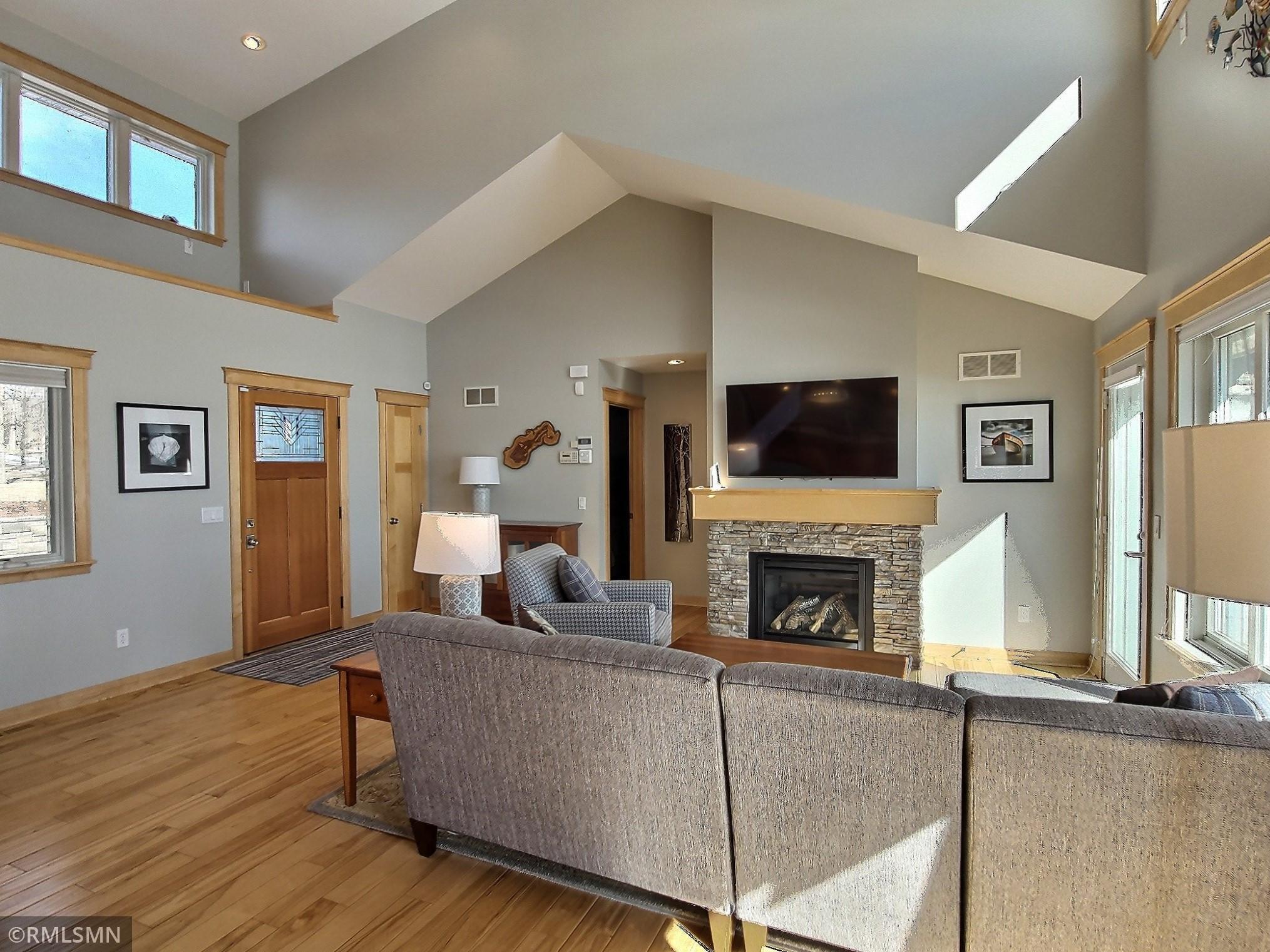 The hardwood floors run through this area of the home. You have a large entry area when you enter the home and you might need with all your lake guests.