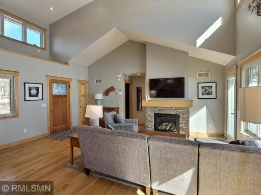The hardwood floors run through this area of the home. You have a large entry area when you enter the home and you might need with all your lake guests.