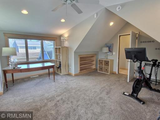 Above the garage is the flex room to be used in a variety of ways. As you will see the versatility of this room as it is currently used as home office, exercise area, sleeping quarters and TV viewing area. With still room to move around.
