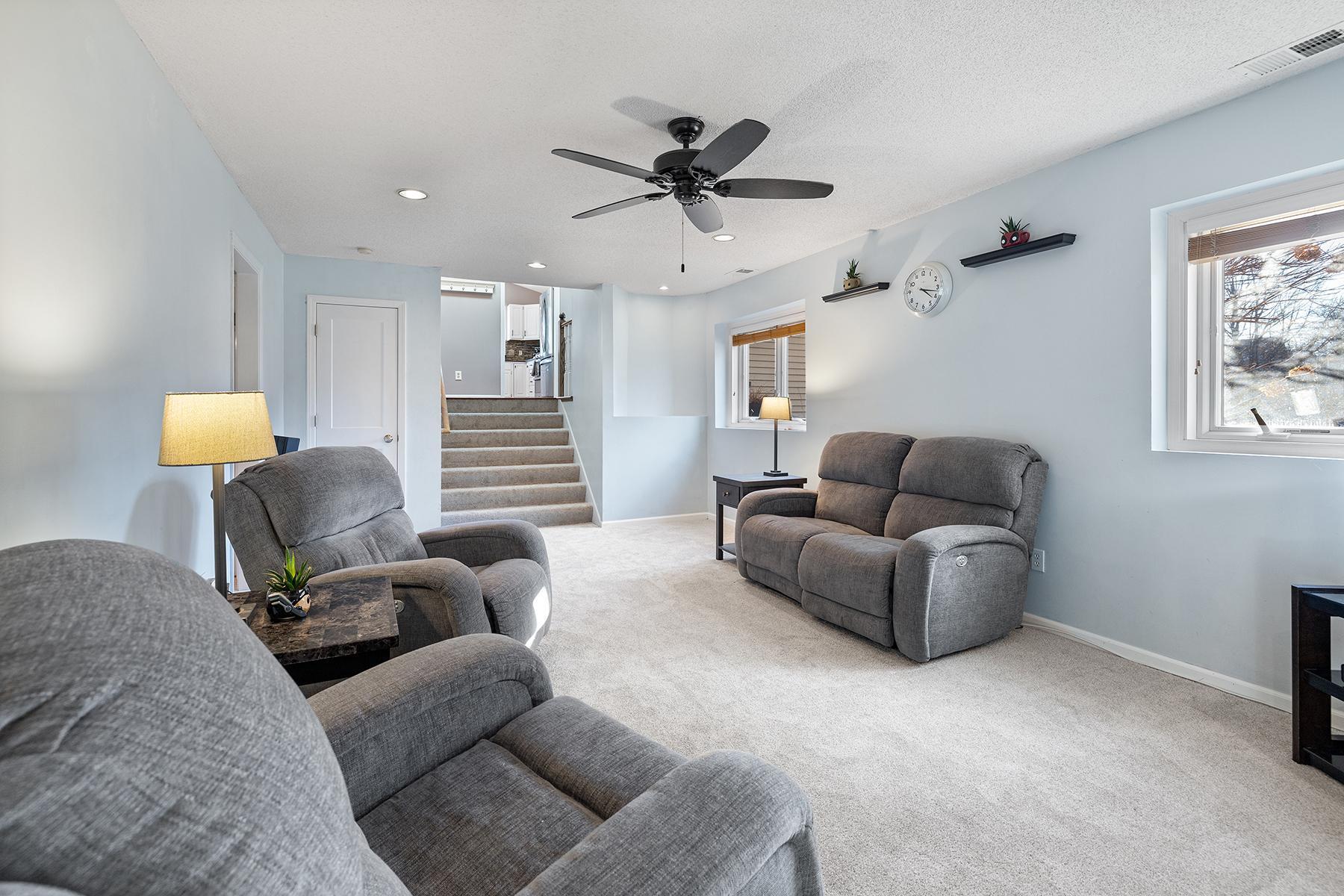 Family room, closet door under stairs leads to extensive crawl space storage room