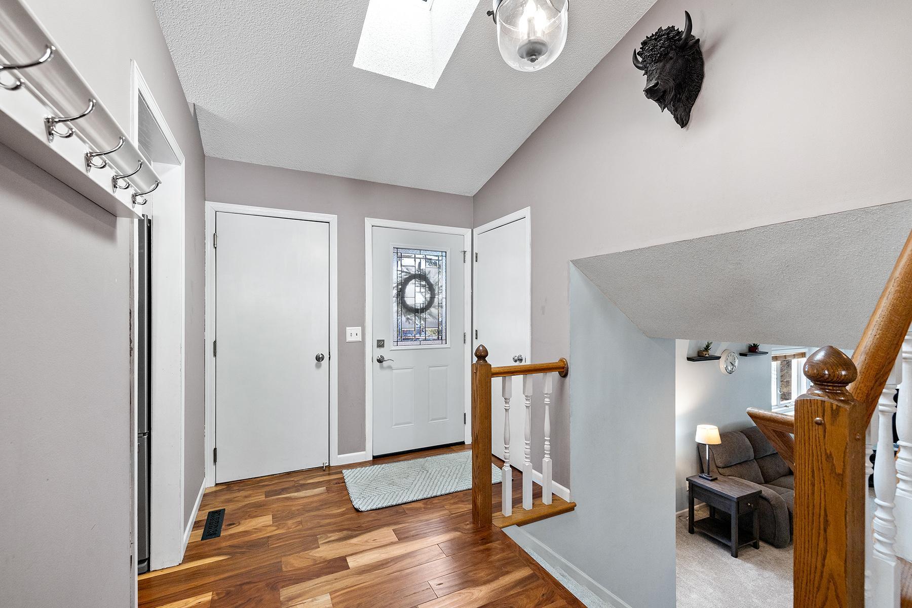 Front foyer entryway for garage and front door. Skylight lets in lots of natural light