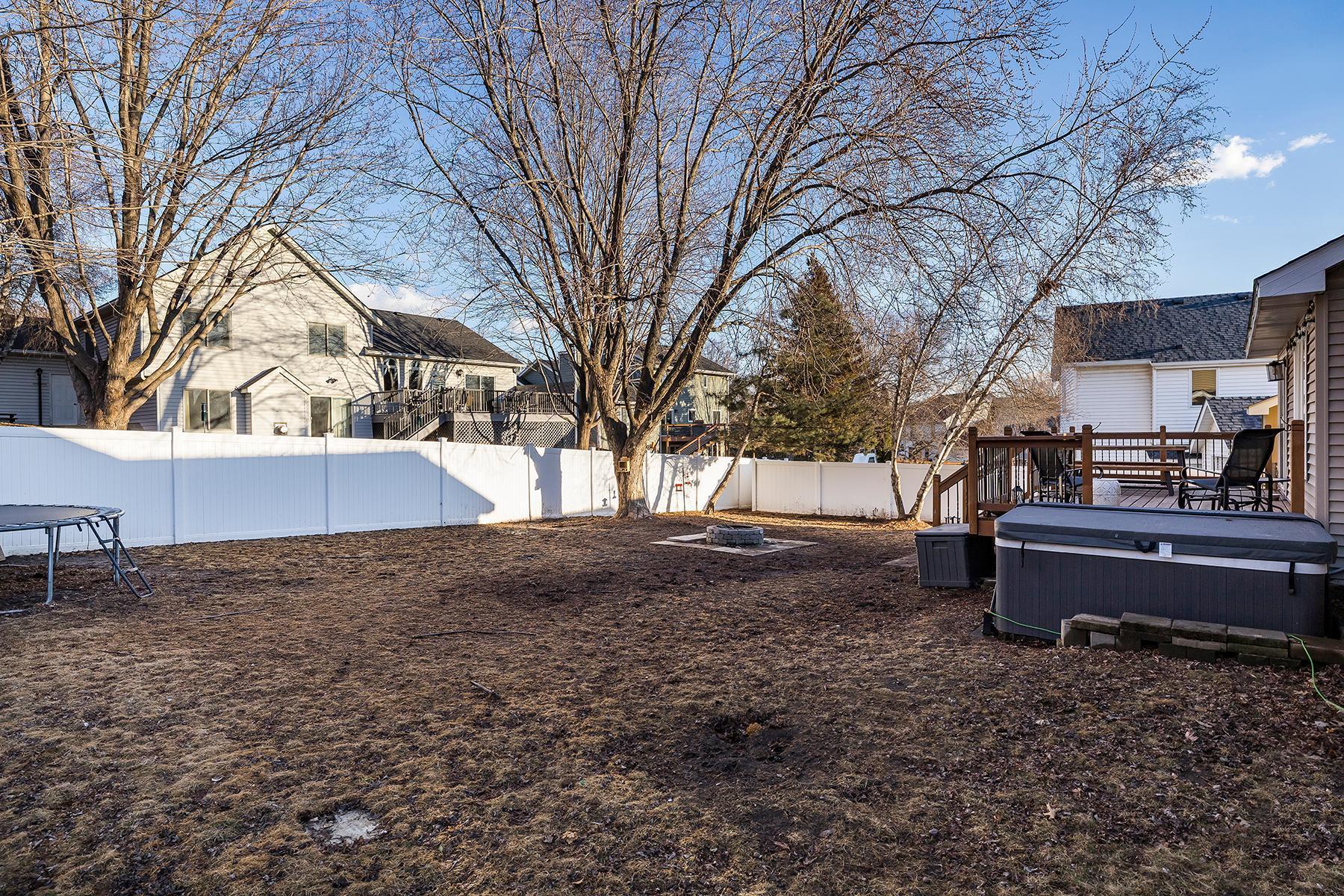 Backyard with hot tub and fire ring