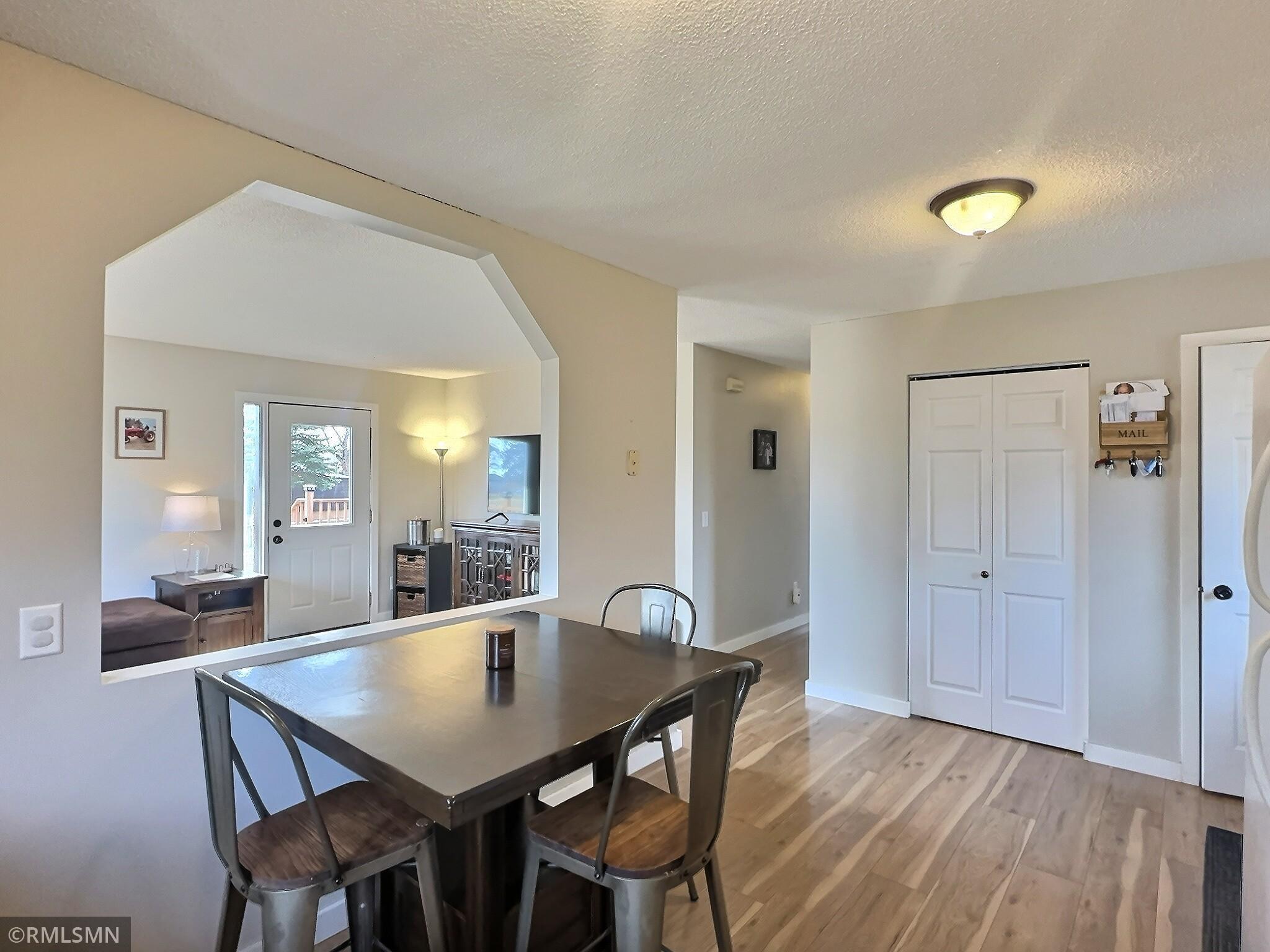 View of the foyer area with a coat closet that can double as a spacious pantry, to the left is the living room.