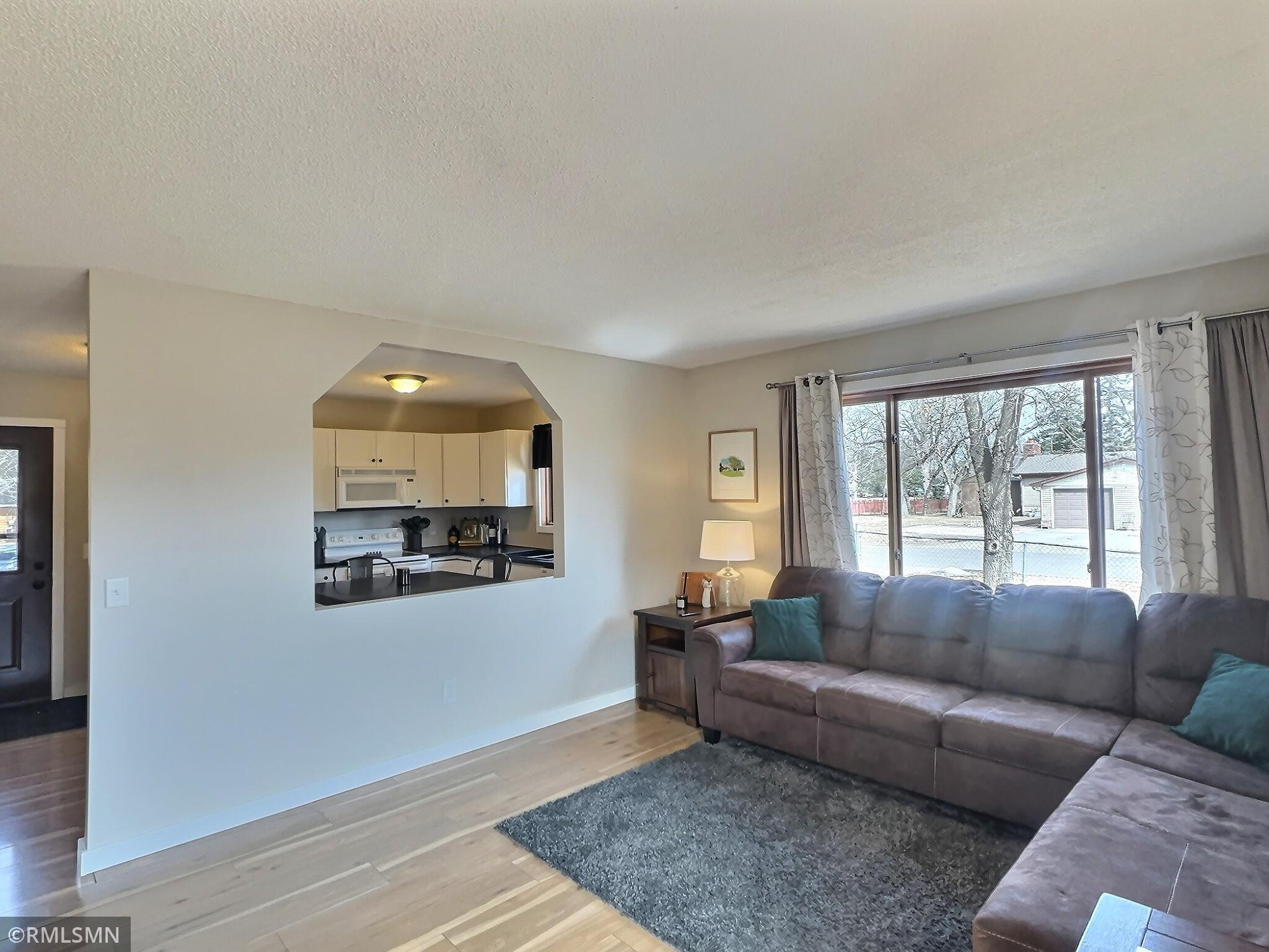 Gather in the living room, the unique opening to the kitchen makes you feel like you a part of the conversation.