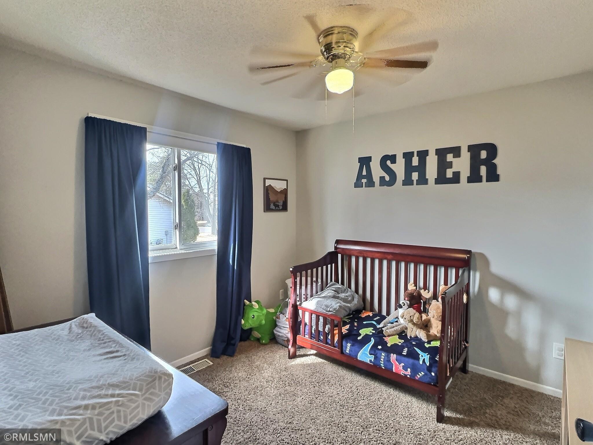 Find a quiet moment in the third main level bedroom complete with fresh carpet & paint and ceiling fan.