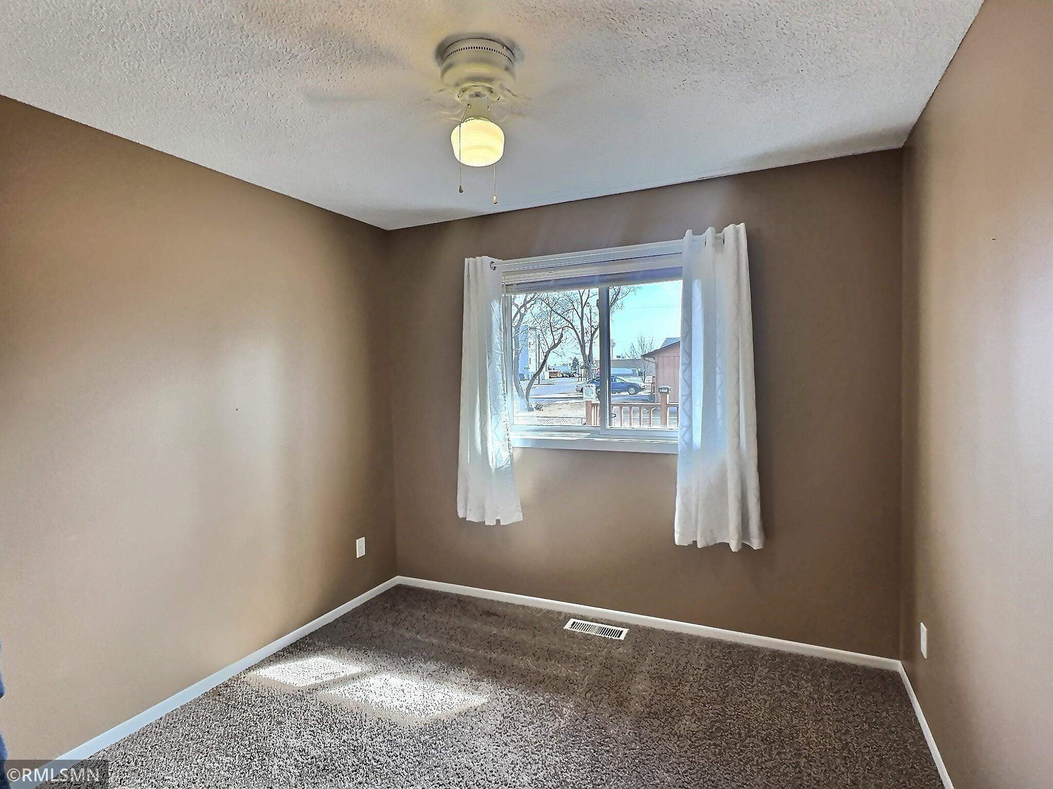Settle in for the night in one of three main level bedrooms including fresh carpet & paint and ceiling fan.