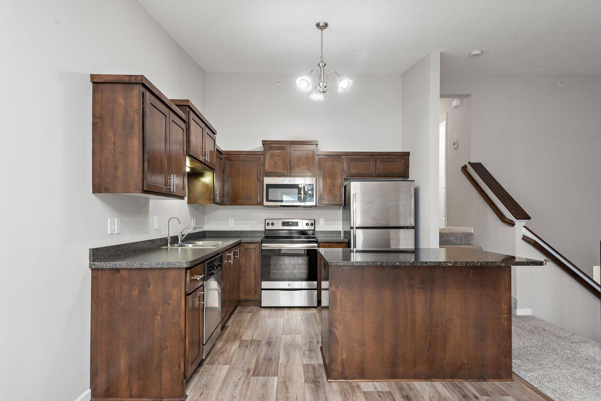 Nice Kitchen with Granite Center Island, Stainless Steel appliances and Open to Dining Room and Living Room