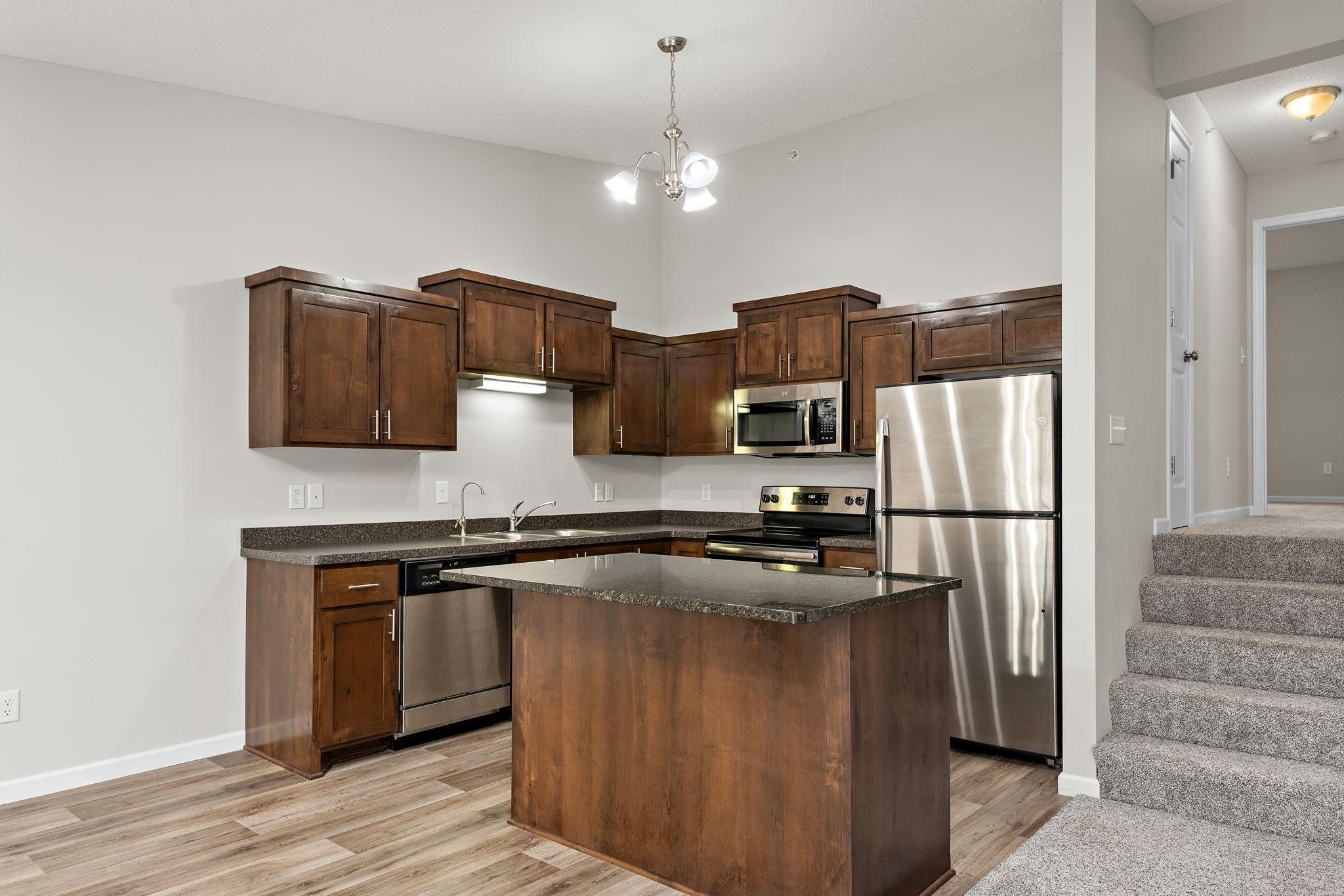 Nice Kitchen with Granite Center Island, Stainless Steel appliances and Open to Dining Room and Living Room